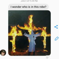 lambert picture text of picture of man in white KKK robes infront of three burning crosses, with "I wonder who is in this robe? in a text above the picture