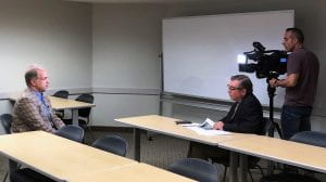 Prof. Dietz being interviewed with a reporter and a cameraman and a TV camera.
