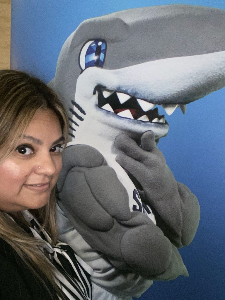 Female student with photo of a cartoon shark