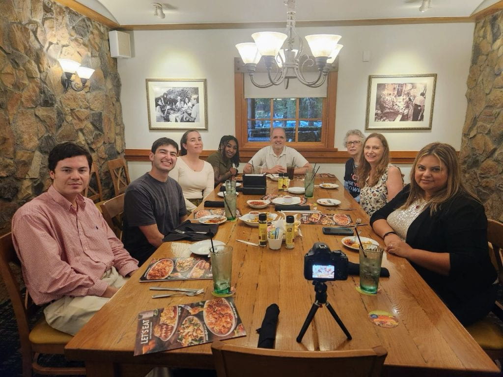 eight people around a wooden table