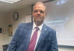 Professor Dietz in a Blue Blazer and red tie