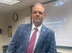 Professor Dietz in a blue checkered blazer and red tie